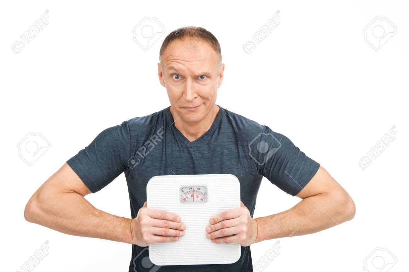 29469390-disappointed-aged-man-squeezing-scales-upset-male-holding-weight-scales-Stock-Photo.jpg